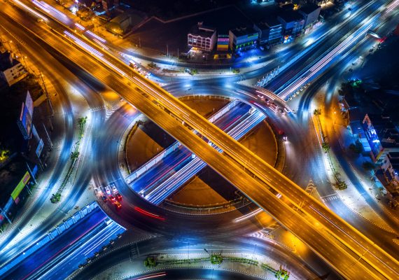 Aerial view of traffic in roundabout and highway at night. Aerial view of traffic in roundabout and highway at night.