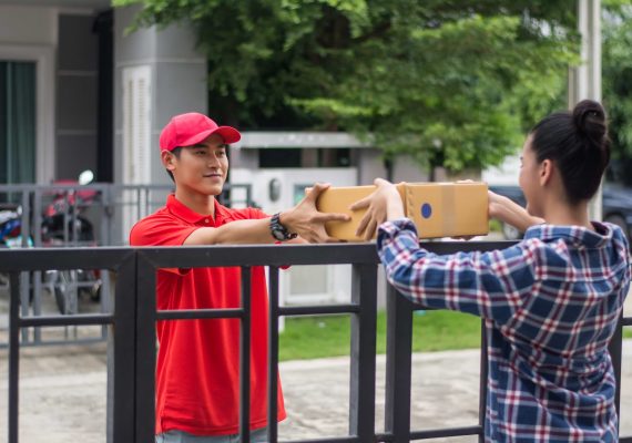young-man-delivering-package-customer-home-delivery (1) young-man-delivering-package-customer-home-delivery (1)