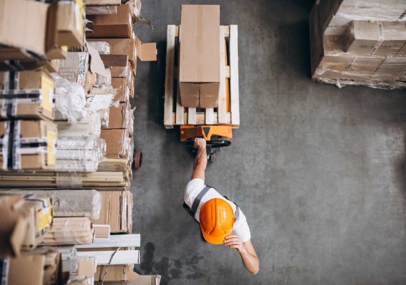 young-man-working-warehouse-with-boxes